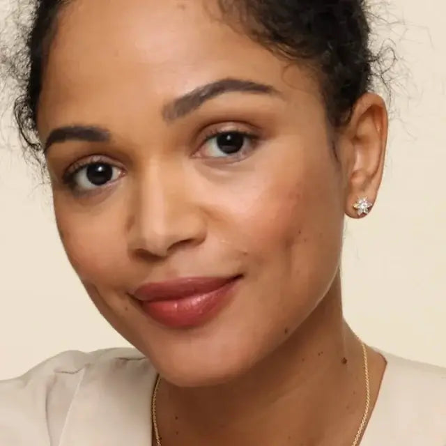 2nd model wearing flower shaped pear and round diamonds yellow gold stud earrings