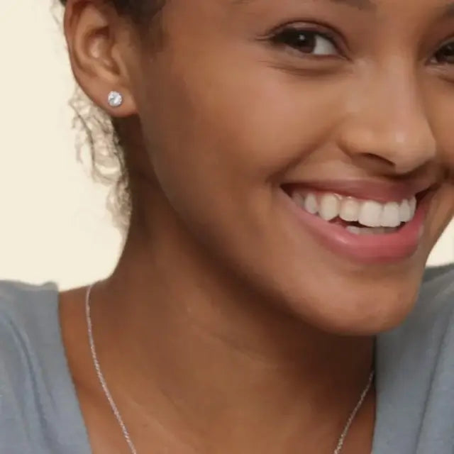 female model wearing a 14k white gold halo earring
