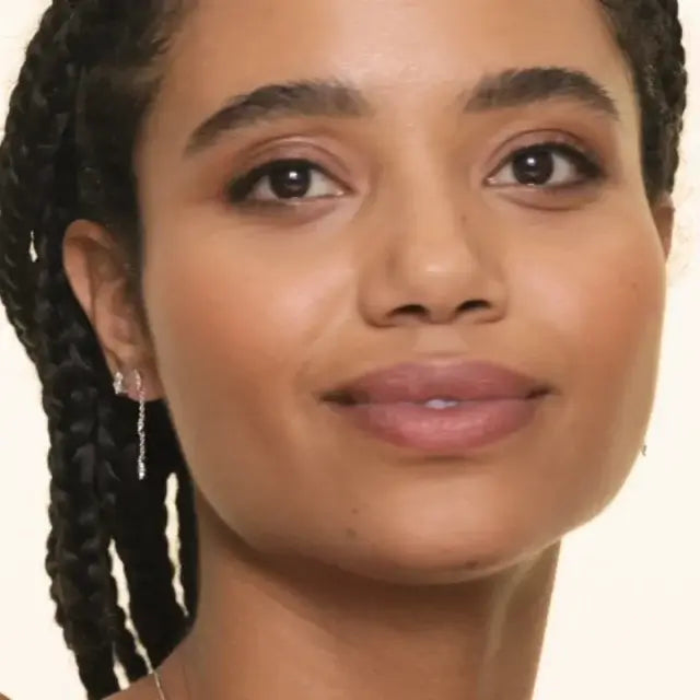 female model wearing a diamond drop earring