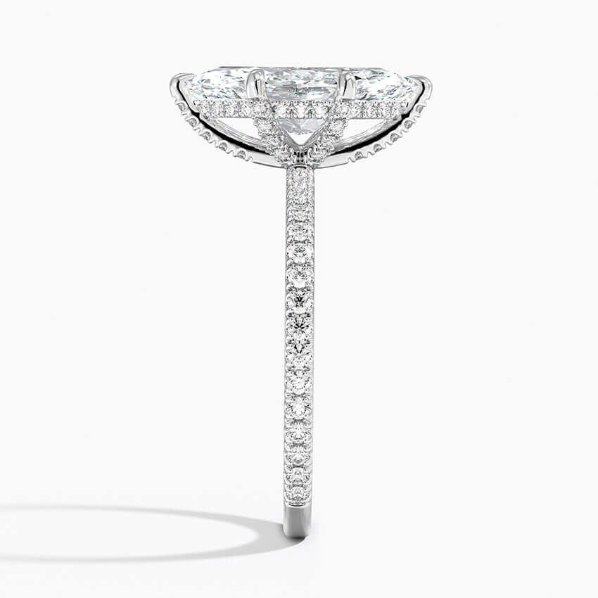 marquise cut diamond with claw prongs and pave setting side white