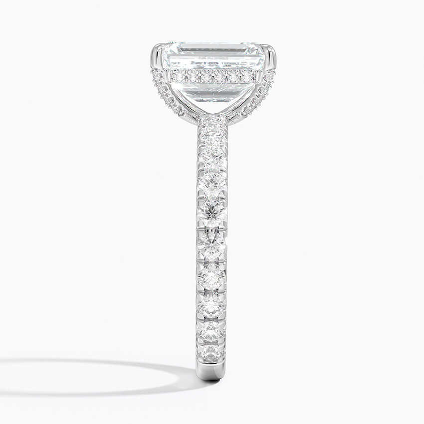 Emerald cut engagement ring white gold claw prongs diamond set side view