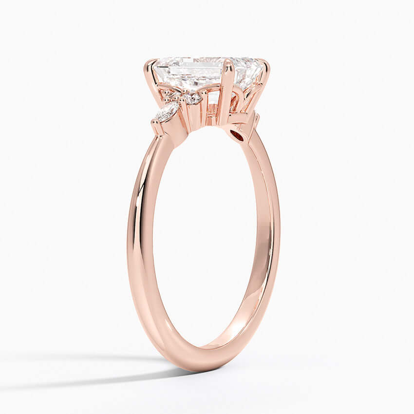 engagement ring emerald cut diamond with marquise and round diamonds on the side 14k rose gold