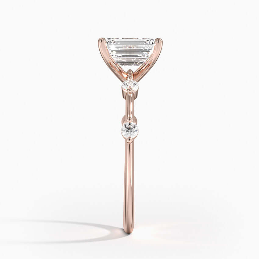 emerald cut diamond engagement ring with 4 diamonds on sides rose gold side view