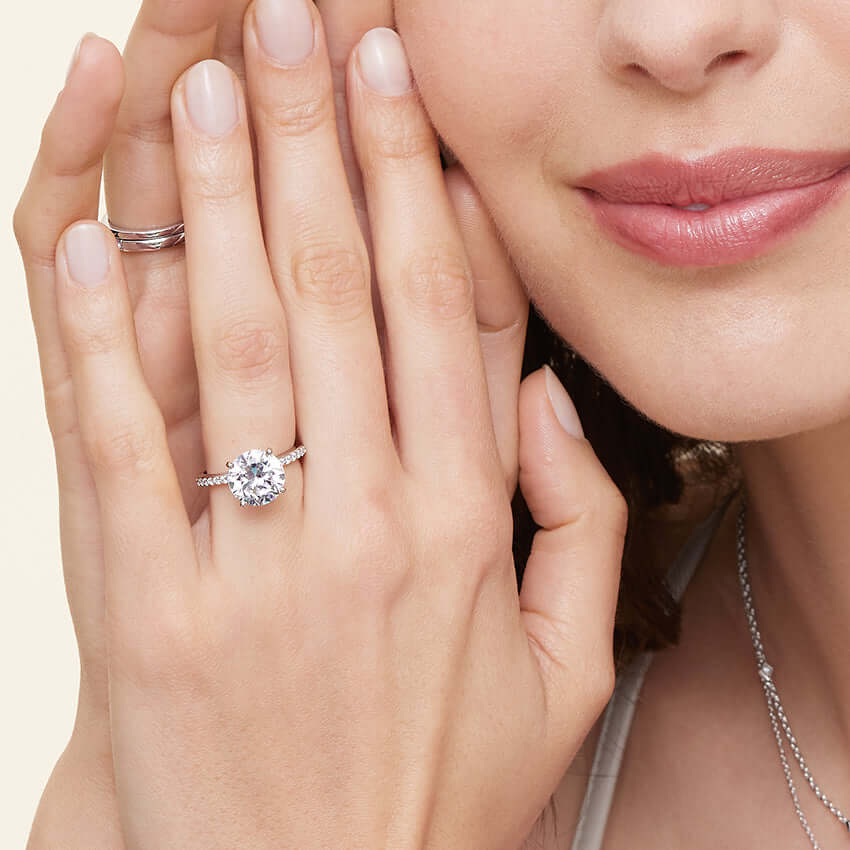 2 model wearing mixed gold brilliant cut lab diamond engagement ring pave set solitaire