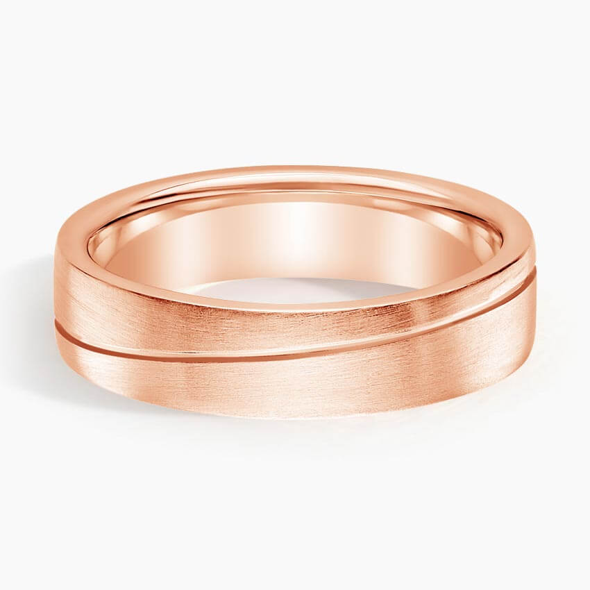 wedding band with an engraved line going across it rose face