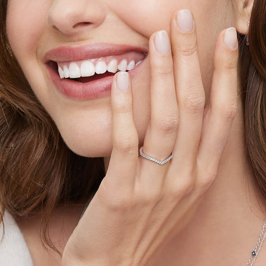 2nd model wearing curved wedding ring diamond set