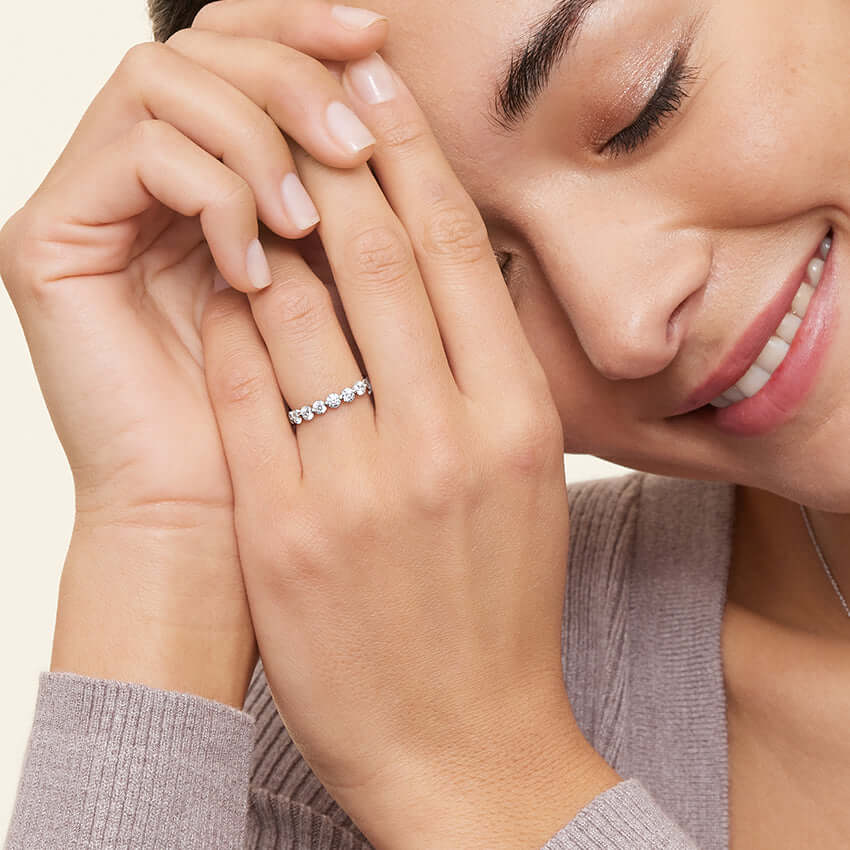 2nd model wearing diamond set shared prong wedding ring white