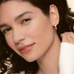 model wearing gold hoop earring