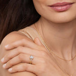 model wearing asscher cut lab diamond with round and marquise on sides 