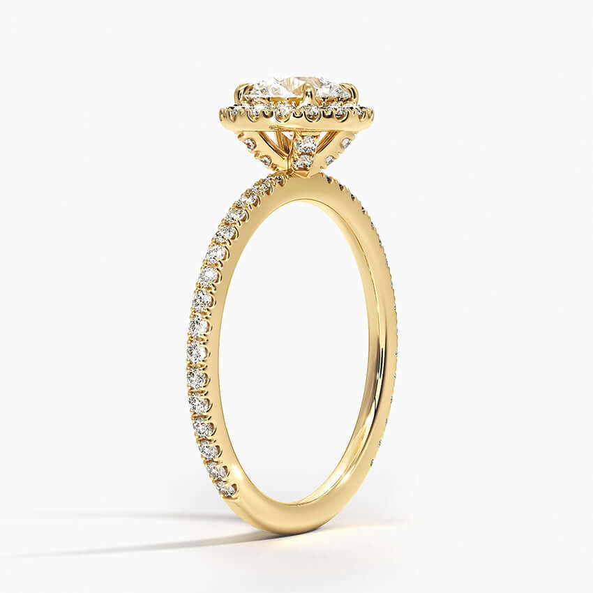 Round diamond halo engagement ring with diamond set bridge yellow gold 