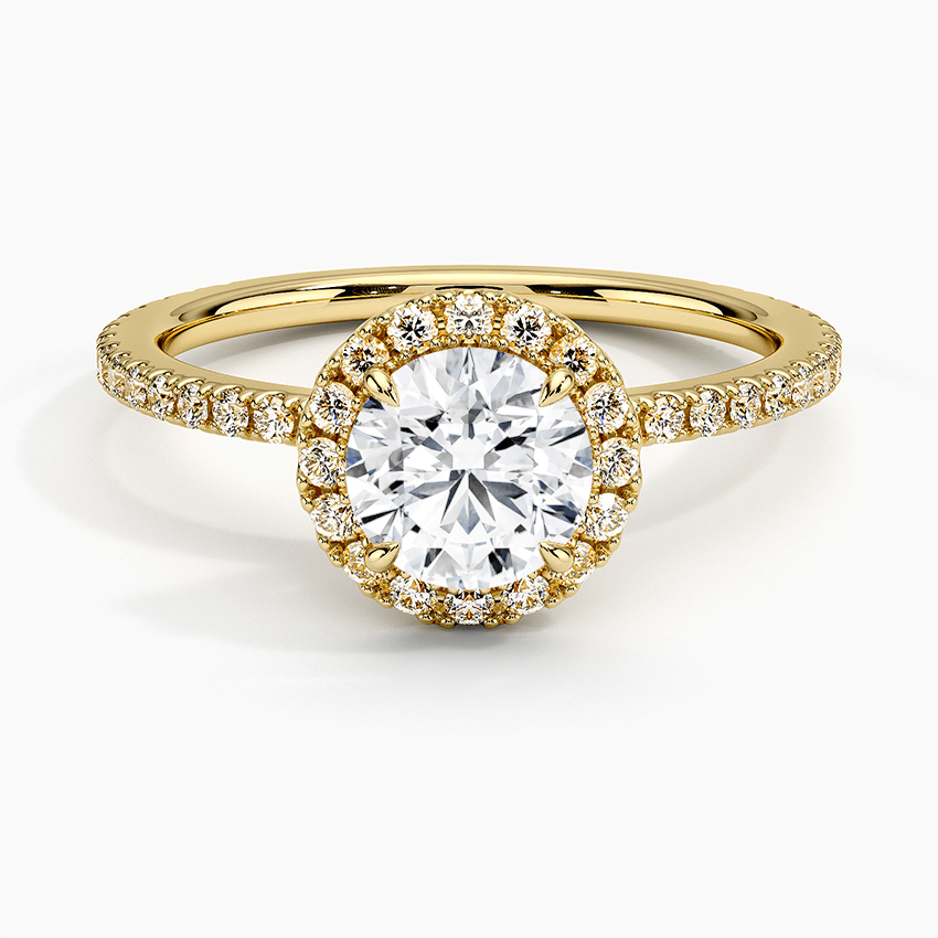 Round diamond halo engagement ring with diamond set bridge yellow gold face view