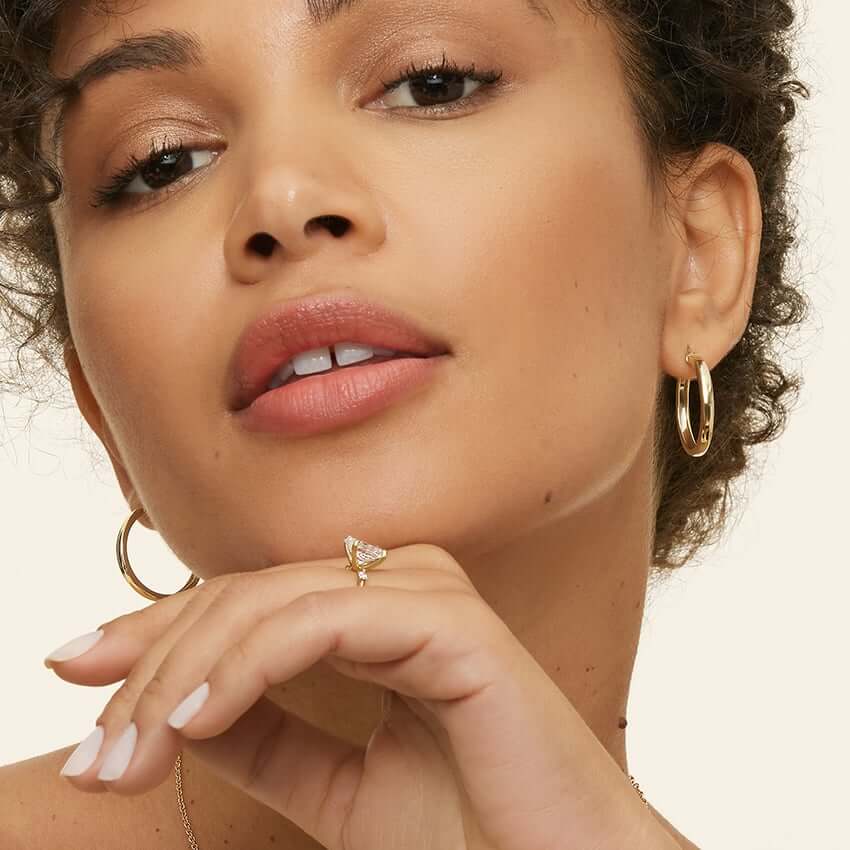 2nd female model wearing golden earrings