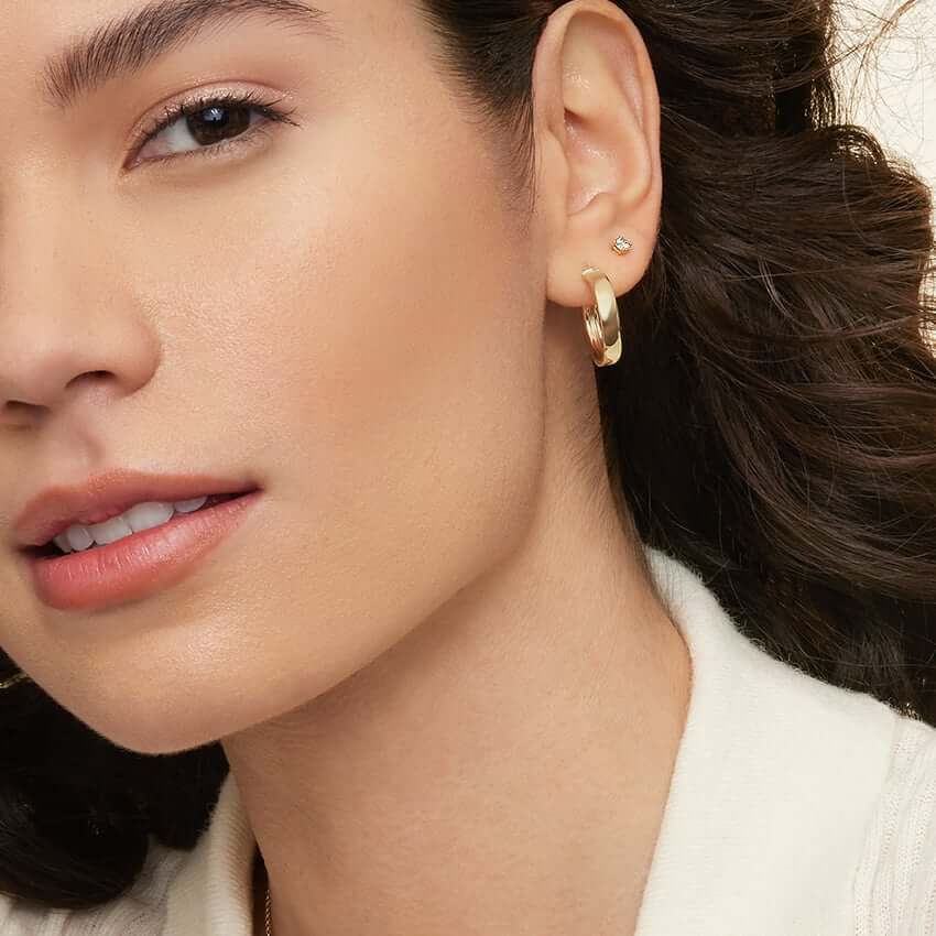 3rd model wearing hoop earrings