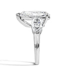 Diamond ring with a pear cut stone on a white background