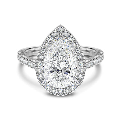 Diamond ring with pear-shaped center stone and halo on a white background
