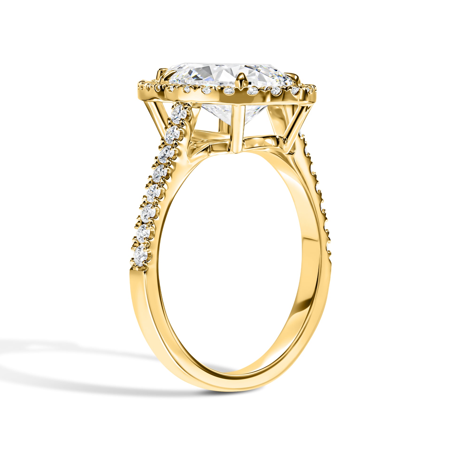 Gold ring with a large diamond and smaller diamonds on the band against a white background
