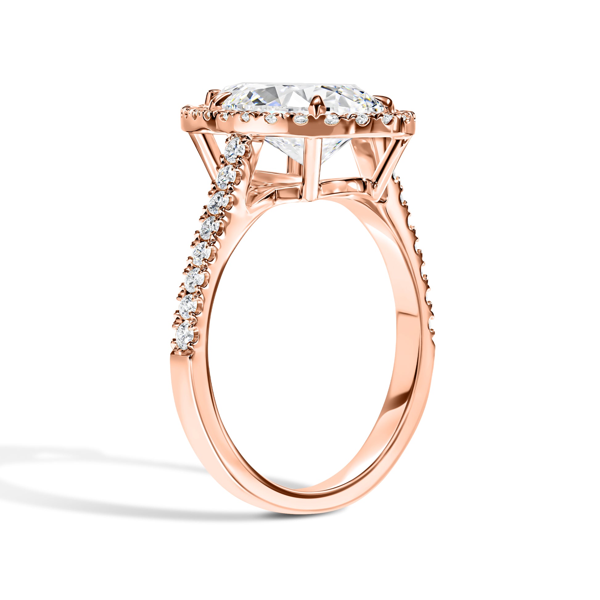 Rose gold ring with a large central diamond and smaller diamonds on the band against a white background